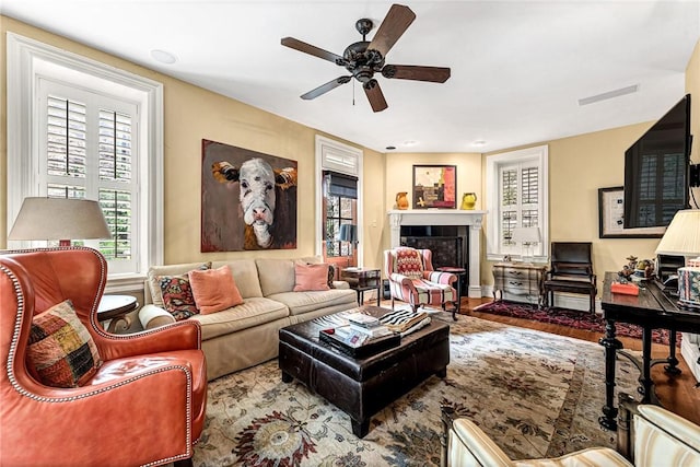 32 Armstrong St, Eureka Springs, AR 72632 - living area with ceiling fan, wood finished floors, and a tile fireplace