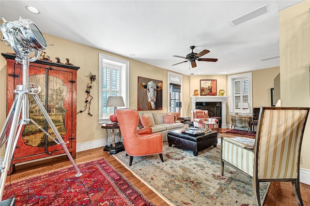32 Armstrong St, Eureka Springs, AR 72632 - living room with wood finished floors, a ceiling fan, a fireplace, and recessed lighting