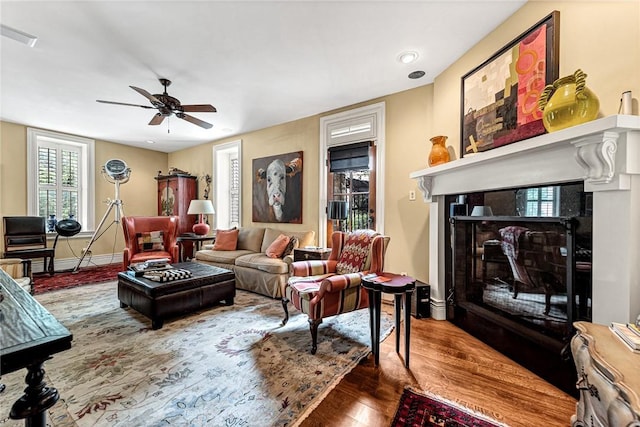 32 Armstrong St, Eureka Springs, AR 72632 - living area featuring a fireplace, wood finished floors, and ceiling fan