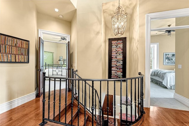 32 Armstrong St, Eureka Springs, AR 72632 - hall with an upstairs landing, a chandelier, and wood finished floors