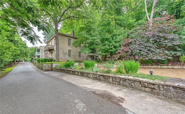 32 Armstrong St, Eureka Springs, AR 72632 - view of front of house with stone siding and a balcony