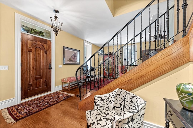 32 Armstrong St, Eureka Springs, AR 72632 - entrance foyer featuring wood finished floors, stairs, and a chandelier