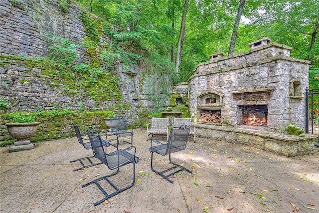 32 Armstrong St, Eureka Springs, AR 72632 - view of patio featuring an outdoor stone fireplace