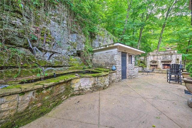 32 Armstrong St, Eureka Springs, AR 72632 - view of patio / terrace featuring an outdoor stone fireplace