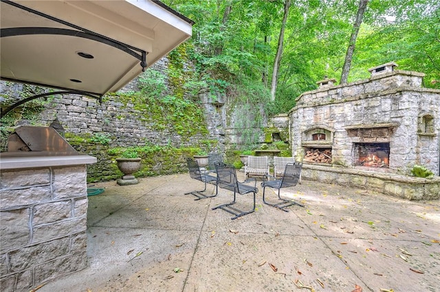 32 Armstrong St, Eureka Springs, AR 72632 - view of patio / terrace with an outdoor stone fireplace