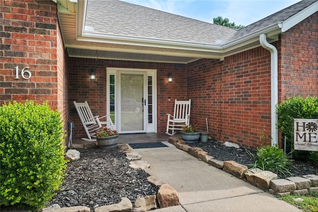 16 Olmsted Ln, Bella Vista, AR 72715 - view of exterior entry with roof with shingles and brick siding