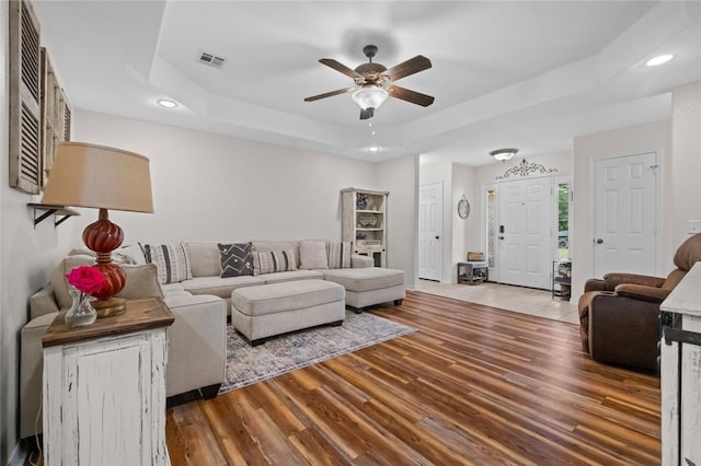 16 Olmsted Ln, Bella Vista, AR 72715 - living room featuring ceiling fan, recessed lighting, a tray ceiling, and wood finished floors