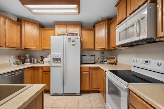 16 Olmsted Ln, Bella Vista, AR 72715 - kitchen featuring white appliances, light tile patterned floors, light countertops, and brown cabinetry