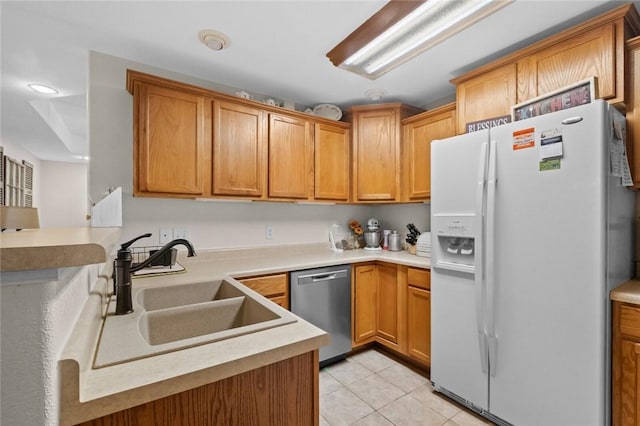 16 Olmsted Ln, Bella Vista, AR 72715 - kitchen featuring white refrigerator with ice dispenser, stainless steel dishwasher, light tile patterned floors, a peninsula, and light countertops