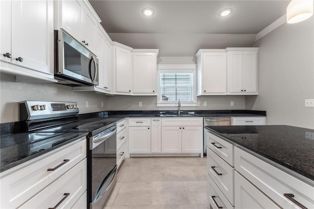 1806 Hudson Dr, Siloam Springs, AR 72761 - kitchen featuring appliances with stainless steel finishes, white cabinetry, dark stone counters, and recessed lighting