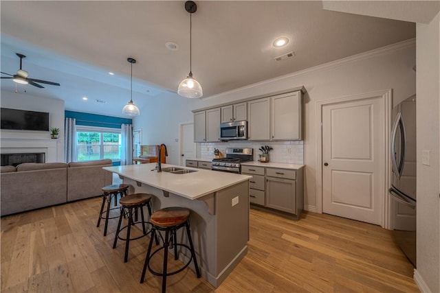 1312 Park St, Lowell, AR 72745 - kitchen with appliances with stainless steel finishes, gray cabinetry, a ceiling fan, light wood-style flooring, and recessed lighting