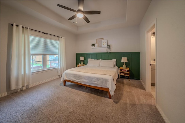 1312 Park St, Lowell, AR 72745 - carpeted bedroom featuring a tray ceiling and a ceiling fan