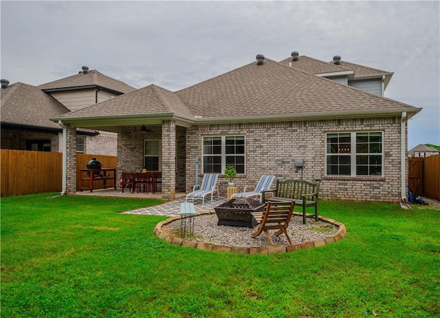 1312 Park St, Lowell, AR 72745 - rear view of property featuring a fenced backyard, an outdoor fire pit, a patio, a shingled roof, and brick siding