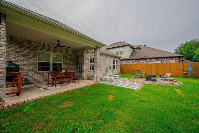 1312 Park St, Lowell, AR 72745 - view of yard featuring a fire pit, a patio area, and ceiling fan