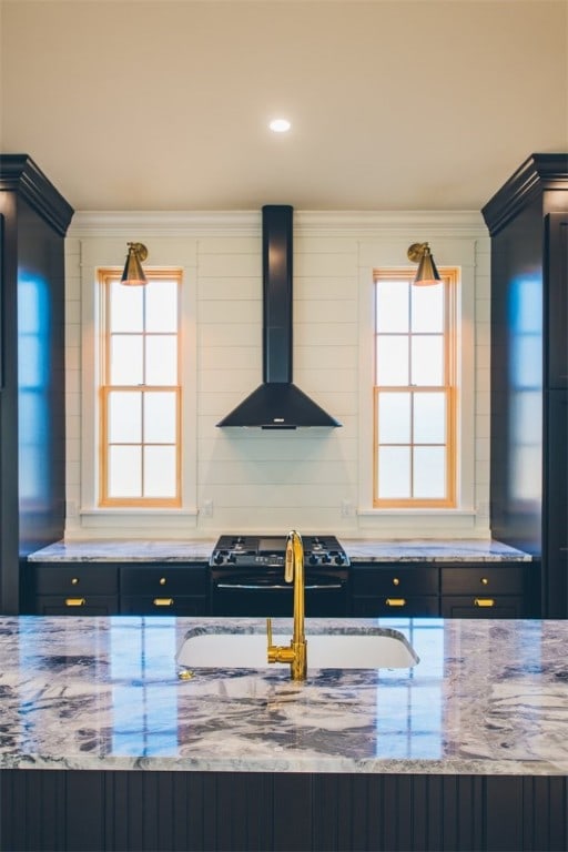 218 E S St, Fayetteville, AR 72701 - kitchen with wall chimney exhaust hood, gas stove, crown molding, light stone counters, and healthy amount of natural light