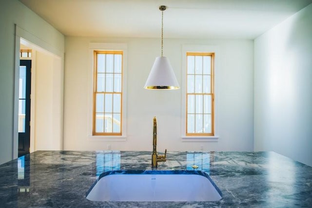 218 E S St, Fayetteville, AR 72701 - kitchen view of dark stone countertops and decorative light fixtures