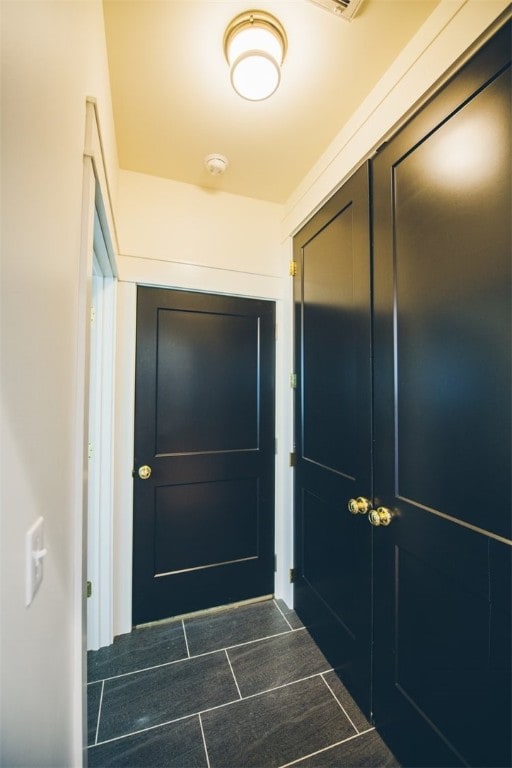 218 E S St, Fayetteville, AR 72701 - doorway to outside featuring dark tile patterned floors