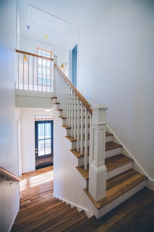 218 E S St, Fayetteville, AR 72701 - stairway with wood finished floors, attic access, and a towering ceiling