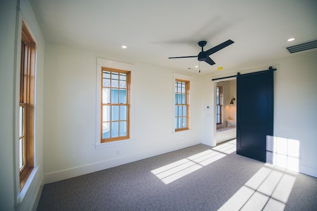 218 E S St, Fayetteville, AR 72701 - spare room with a barn door, ceiling fan, carpet, and recessed lighting