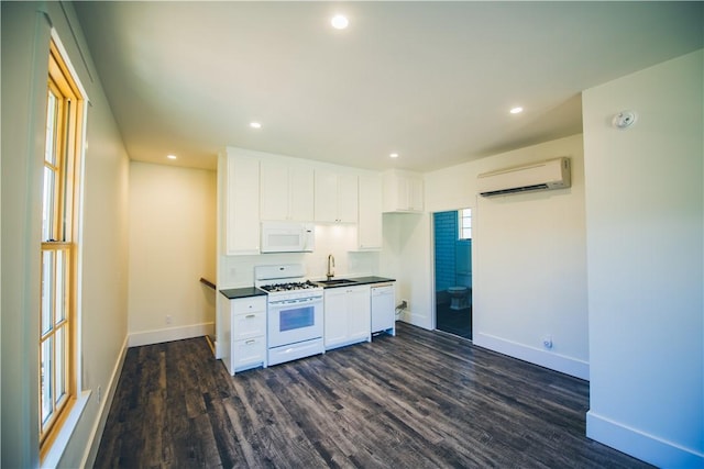 218 E S St, Fayetteville, AR 72701 - kitchen featuring white appliances, a wall mounted air conditioner, white cabinetry, dark wood-type flooring, and recessed lighting