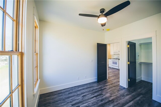 218 E S St, Fayetteville, AR 72701 - unfurnished bedroom with dark wood-style flooring and a ceiling fan