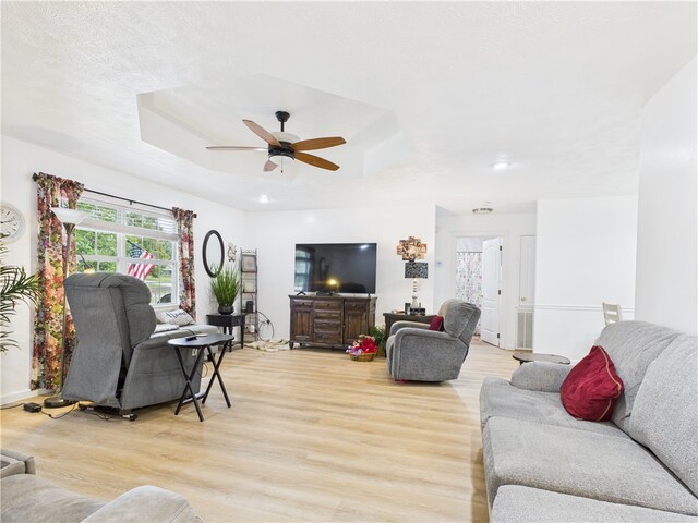 104 Paradise Cove Ln, Berryville, AR 72616 - living room featuring a tray ceiling, light wood-style floors, a ceiling fan, and recessed lighting