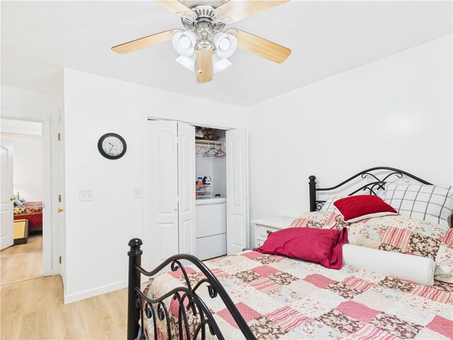 104 Paradise Cove Ln, Berryville, AR 72616 - bedroom with washer / dryer, light wood-style floors, a closet, and a ceiling fan