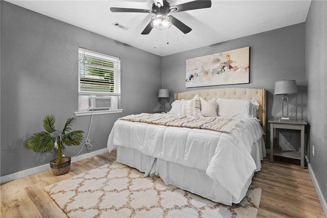 2511 Purdue Cir, Bentonville, AR 72712 - bedroom featuring cooling unit, wood finished floors, and ceiling fan