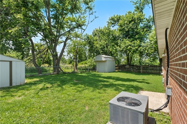 2511 Purdue Cir, Bentonville, AR 72712 - fenced backyard featuring a storage shed and view of wooded area