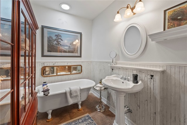 8252 Hickory Tree Ln, Rogers, AR 72756 - bathroom with a wainscoted wall, a freestanding tub, wood walls, and tile patterned flooring