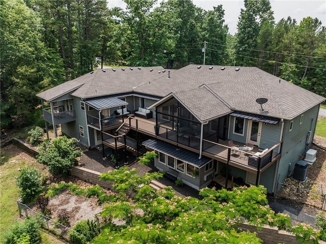 8252 Hickory Tree Ln, Rogers, AR 72756 - back of house featuring a shingled roof, a deck, and a sunroom