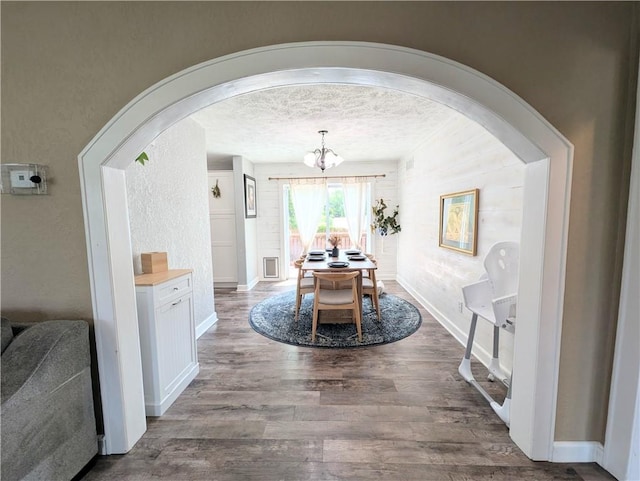 805 S Oak St, Harrison, AR 72601 - dining space featuring arched walkways, dark wood-style floors, a chandelier, and a textured ceiling