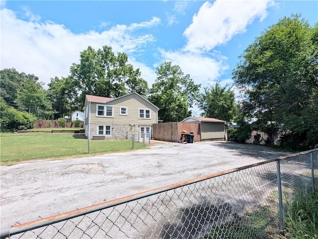805 S Oak St, Harrison, AR 72601 - view of front of house featuring asphalt driveway, stone siding, and an outbuilding