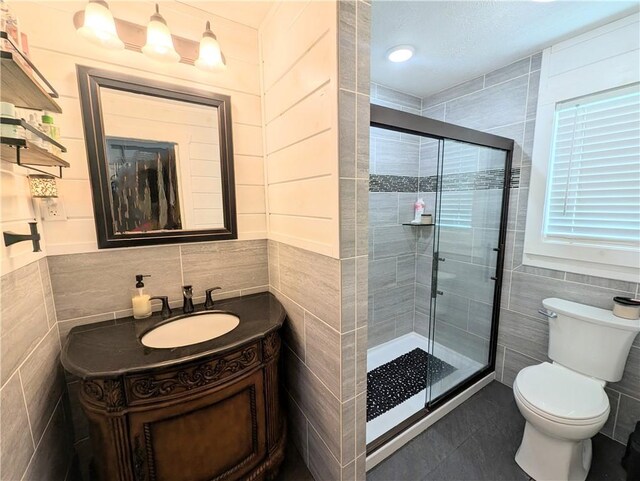 805 S Oak St, Harrison, AR 72601 - full bathroom featuring tile walls, a stall shower, vanity, and tile patterned flooring