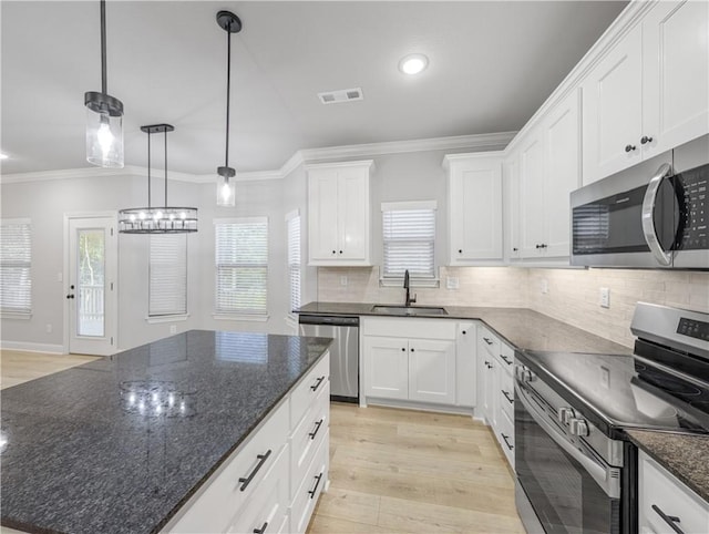 11 Dornoch Cir, Bella Vista, AR 72715 - kitchen with appliances with stainless steel finishes, ornamental molding, backsplash, white cabinetry, and plenty of natural light