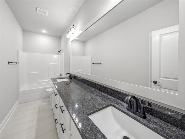 11 Dornoch Cir, Bella Vista, AR 72715 - bathroom with double vanity,  shower combination, and recessed lighting