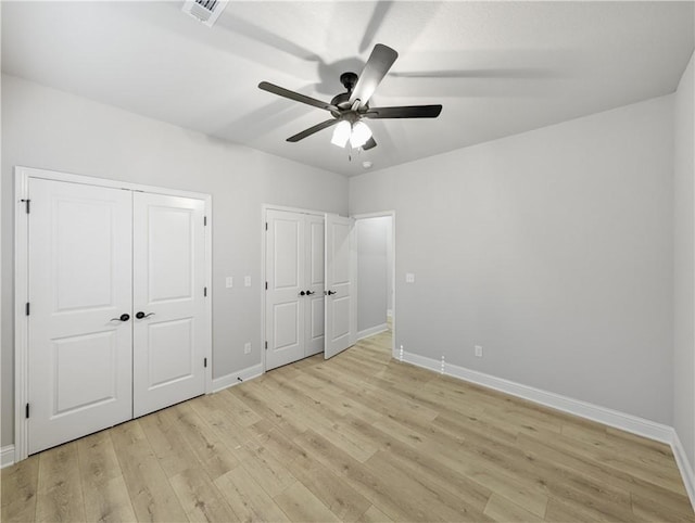 11 Dornoch Cir, Bella Vista, AR 72715 - unfurnished bedroom featuring multiple closets, light wood-style floors, and ceiling fan