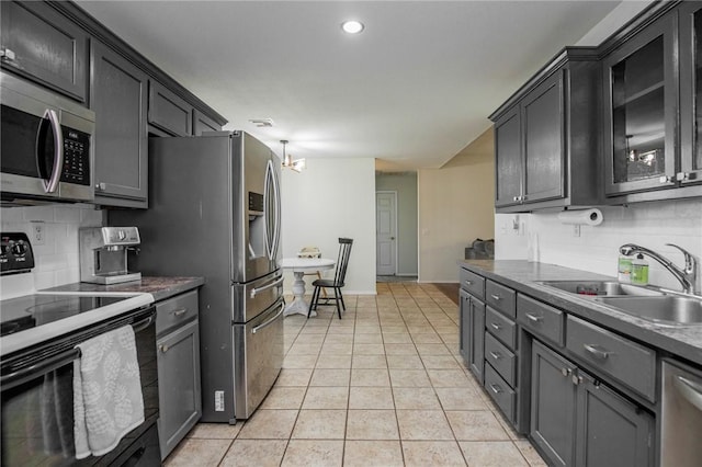 1041 Evergreen St, Centerton, AR 72719 - kitchen featuring appliances with stainless steel finishes, backsplash, light tile patterned floors, a chandelier, and recessed lighting