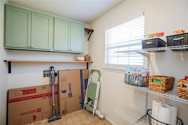 1041 Evergreen St, Centerton, AR 72719 - laundry area featuring cabinet space and light tile patterned floors