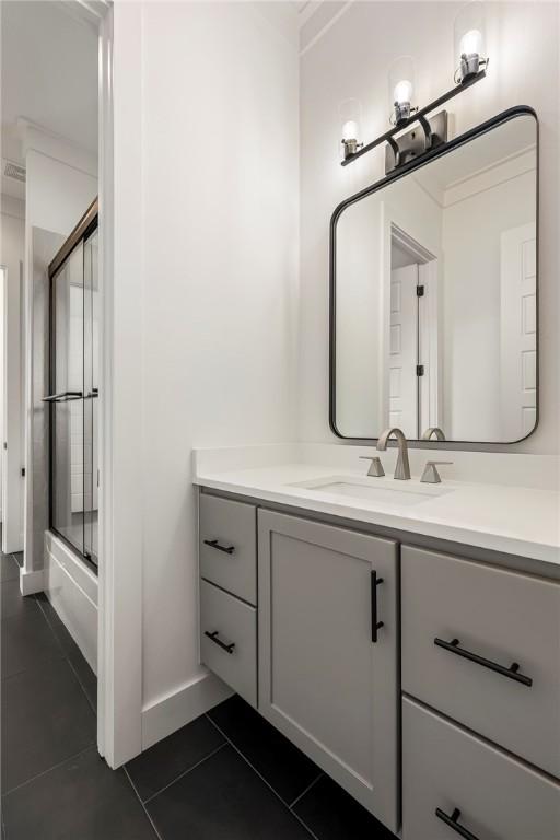 8002 W Claverton St, Rogers, AR 72758 - bathroom featuring vanity, tile patterned floors, and bath / shower combo with glass door