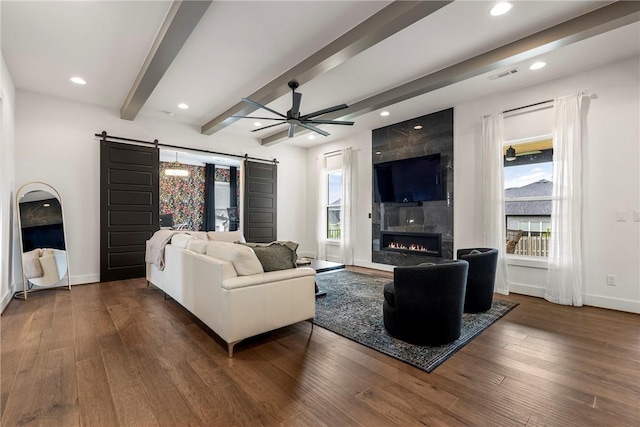 8002 W Claverton St, Rogers, AR 72758 - living area with a barn door, plenty of natural light, wood finished floors, recessed lighting, and beam ceiling