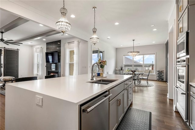 8002 W Claverton St, Rogers, AR 72758 - kitchen featuring appliances with stainless steel finishes, gray cabinetry, light countertops, dark wood-style floors, and recessed lighting