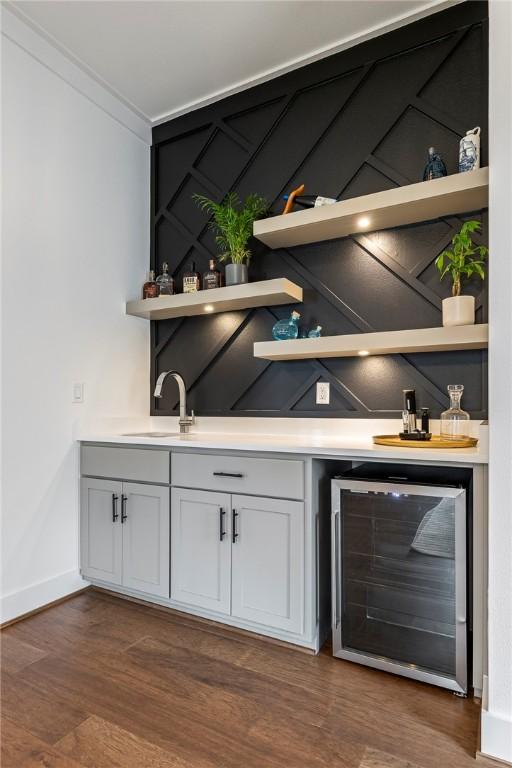 8002 W Claverton St, Rogers, AR 72758 - indoor wet bar featuring wine cooler and dark wood finished floors