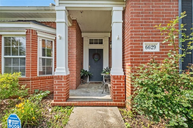 6629 Tall Oaks Loop, Springdale, AR 72762 - view of exterior entry with brick siding and a porch