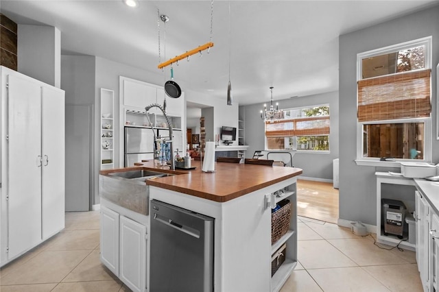 6629 Tall Oaks Loop, Springdale, AR 72762 - kitchen with appliances with stainless steel finishes, wooden counters, a chandelier, a kitchen island with sink, and light tile patterned flooring