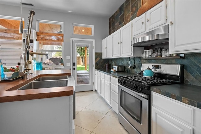 6629 Tall Oaks Loop, Springdale, AR 72762 - kitchen with stainless steel gas range, wall chimney range hood, dark countertops, and backsplash