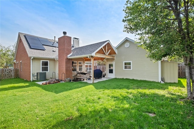 6629 Tall Oaks Loop, Springdale, AR 72762 - back of house with solar panels, a patio area, roof with shingles, a chimney, and brick siding