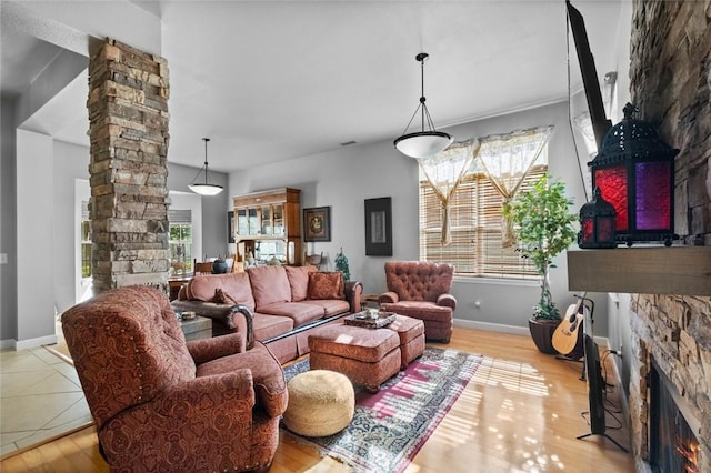 6629 Tall Oaks Loop, Springdale, AR 72762 - living area with ornate columns, a stone fireplace, and wood finished floors