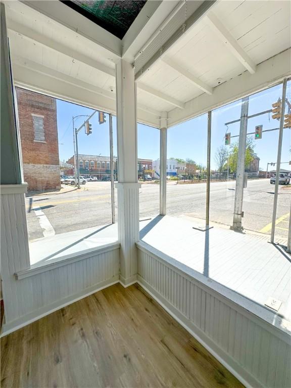108 Public Sq, Berryville, AR 72616 - unfurnished sunroom featuring healthy amount of natural light and beamed ceiling