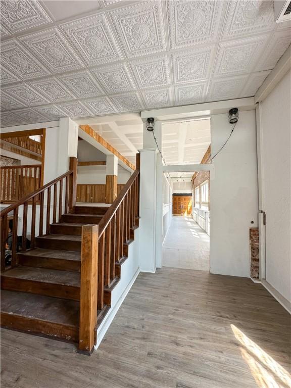 108 Public Sq, Berryville, AR 72616 - stairs with wood finished floors and an ornate ceiling